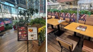 EX GARDEN CAFE店内のテーブル席と流れるアニメ映像、コラボポスター